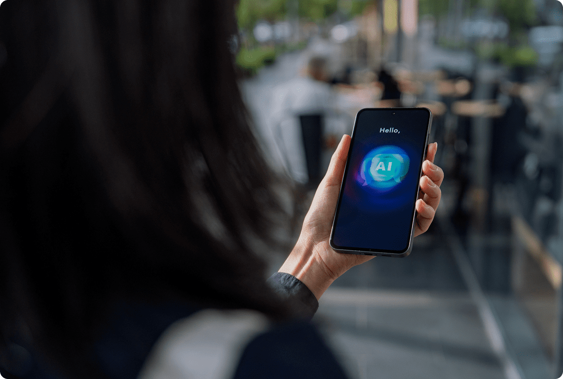 Person holding smartphone with AI screen